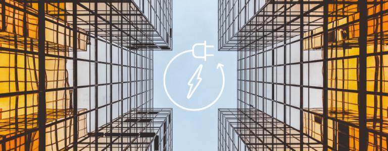 Két üvegépület között, alulnézetben, középen az energiatermelés ikonjával